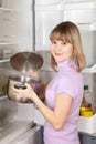 Woman looking into pan from refrigerator Royalty Free Stock Photo