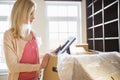 Woman looking at photo frame while unpacking moving boxes at new house Royalty Free Stock Photo