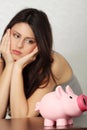 Woman looking at piggy bank Royalty Free Stock Photo