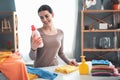 Woman looking at pink bottle during laundry at home Royalty Free Stock Photo