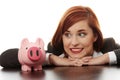 Woman looking on pink piggy bank Royalty Free Stock Photo