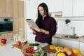 Woman looking recipe vegetable salad tablet Simple healthy cooking vegetable