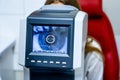 Woman looking at refractometer eye test machine in ophthalmology, vision correction concept Royalty Free Stock Photo