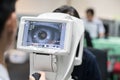 Woman looking at refractometer eye test machine in ophthalmology Royalty Free Stock Photo