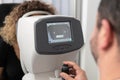 Woman Looking at Refractometer Eye Test Machine Royalty Free Stock Photo