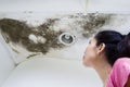 Woman looking at the roof damage Royalty Free Stock Photo