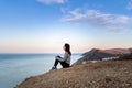 Woman looking on sea in the mountains Royalty Free Stock Photo