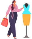 Woman looking on skirt and blouse at dummy. Girl with purchases is choosing outfits on mannequin Royalty Free Stock Photo