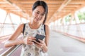Woman looking at smart phone in the foot bridge Royalty Free Stock Photo