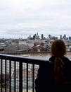 Woman looking at St Pauls Cathedral from Tate Modern lookout. London, United Kingdom. Royalty Free Stock Photo