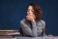 Woman looking at stack of papers at her desk with no desire to work Royalty Free Stock Photo