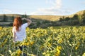 Woman Looking At A Sunflower Field At Sunset