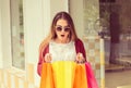 Woman looking surprised into her shopping bags gifts excited with what she has realizing she forgot something in the store having Royalty Free Stock Photo