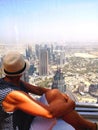 A woman is looking at the tallest freestanding building in the world, the burj khalifa in dubai