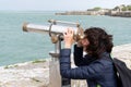 Woman Looking Through Telescope at Beach in island ile de Re in France Royalty Free Stock Photo