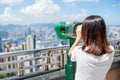 Woman looking though the binocular in the Peak of Hong Kong Royalty Free Stock Photo