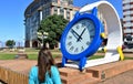 Woman looking at the time in a giant clock. Public park close to Riazor Beach. La Coruna, Spain, 22 Sep 2018. Royalty Free Stock Photo