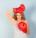 Woman looking tired wearing red boxing gloves