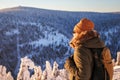 Woman looking to mountains from viewpoint during hiking in winter Royalty Free Stock Photo