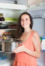 Woman looking in to pan from fridge Royalty Free Stock Photo