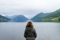 Woman looking towards norwegian fjords