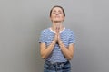 Woman looking up with imploring desperate grimace, praying to god asking for help. Royalty Free Stock Photo