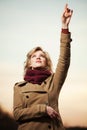 Woman looking up and pointing in the sky Royalty Free Stock Photo