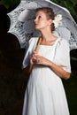 Woman looking upwards white dress lace umbrella Royalty Free Stock Photo