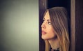 Woman looking who's behind the door? Royalty Free Stock Photo