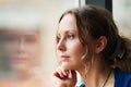 Sad woman looking out window Royalty Free Stock Photo