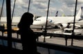 Woman looking through window in the airport. Toned photo Royalty Free Stock Photo