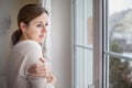 Woman looking from a window of her house Royalty Free Stock Photo