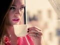 Woman looking through window, relaxing drinking coffee Royalty Free Stock Photo