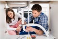 Woman Looking At Worker Fixing Pipe