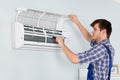 Technician Repairing Air Conditioner At Home Royalty Free Stock Photo