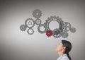 woman lookingup at cog wheels Royalty Free Stock Photo