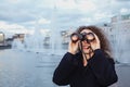 Woman looks through binoculars at sunset Royalty Free Stock Photo