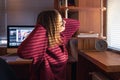 A woman looks through the blinds at the early morning sunlight. Royalty Free Stock Photo