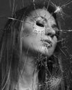 Woman looks through broken glass. Black and white Royalty Free Stock Photo