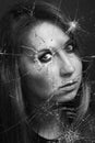 Woman looks through broken glass. Black and white Royalty Free Stock Photo