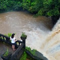 A woman looks at Mena Creek Falls in Paronella Park in Queenland Australia Royalty Free Stock Photo