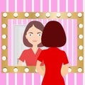 A woman looks in the mirror. Reflection of a woman in a mirror.