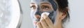 Woman looks in mirror and rinses off cosmetic mask. Royalty Free Stock Photo