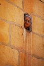 Woman looks out through the small window