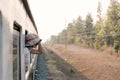 Woman looks out from window traveling by train