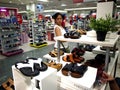 A woman looks at a pair of shoes in the shoe department of SM City mall in Taytay City, Philippines.