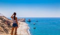 Woman looks on panoramic landscape Petra tou Romiou (The rock of the Greek), Aphrodite& 39s legendary birthplace in Paphos, Royalty Free Stock Photo