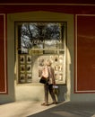 A woman looks at the pictures displayed in the window of a Theatermuseum