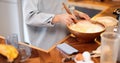 Woman mixing daugh for baking waffles at home