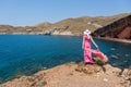 Woman looks at the red beach in Santorini, Greece Royalty Free Stock Photo